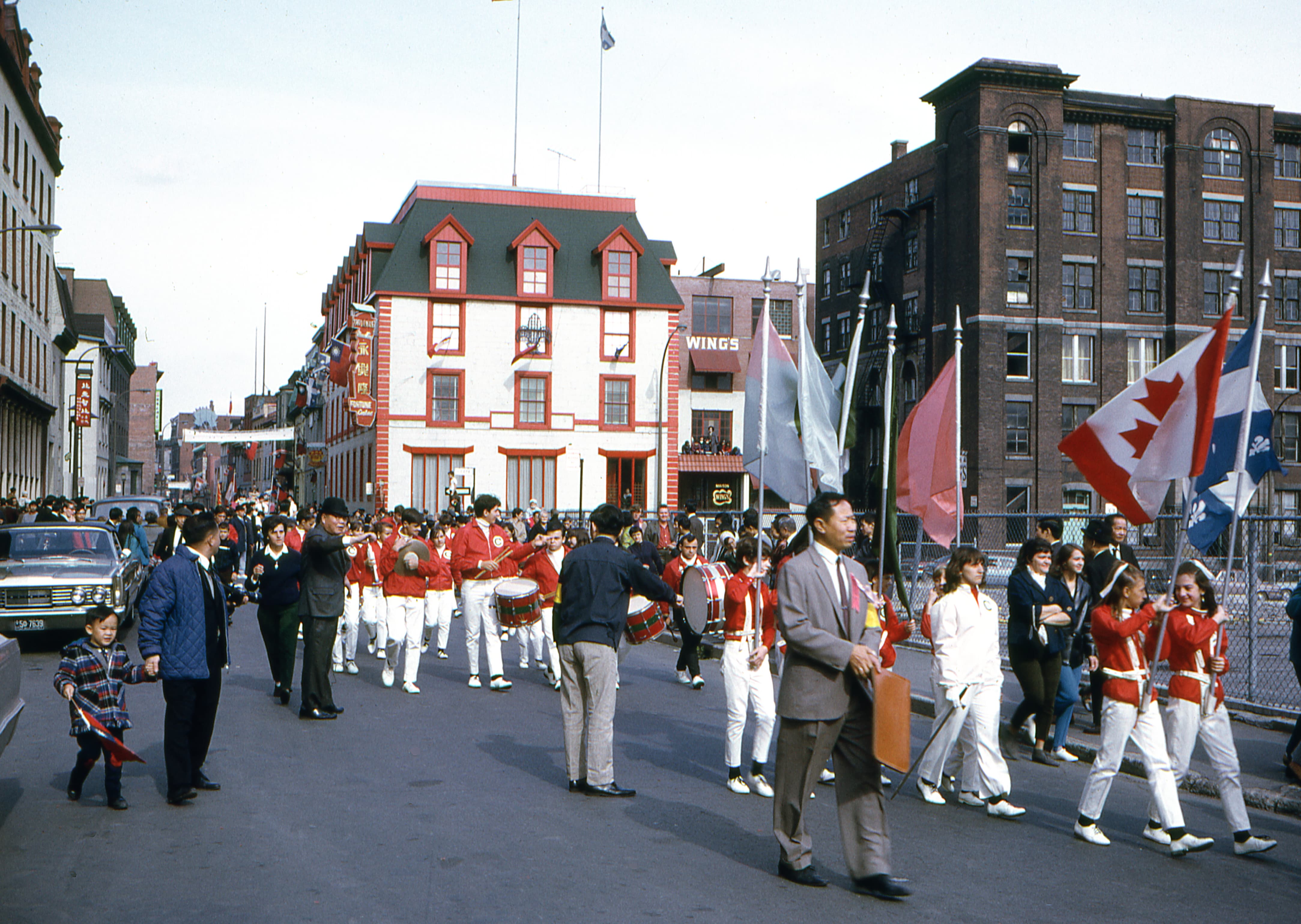 Group of people marching on the street near the Wing’s factory building.