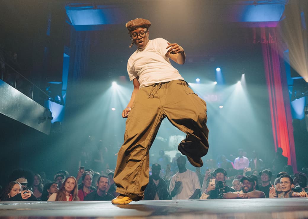 Man breaking on a stage before an enthusiastic audience