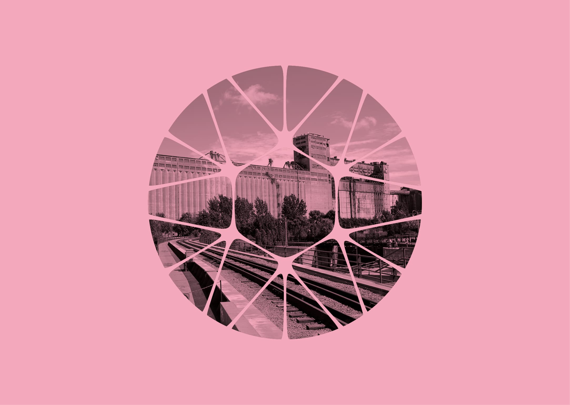 Pink-toned photo of an industrial building and railway tracks, seen through a circular kaleidoscope-like pattern.