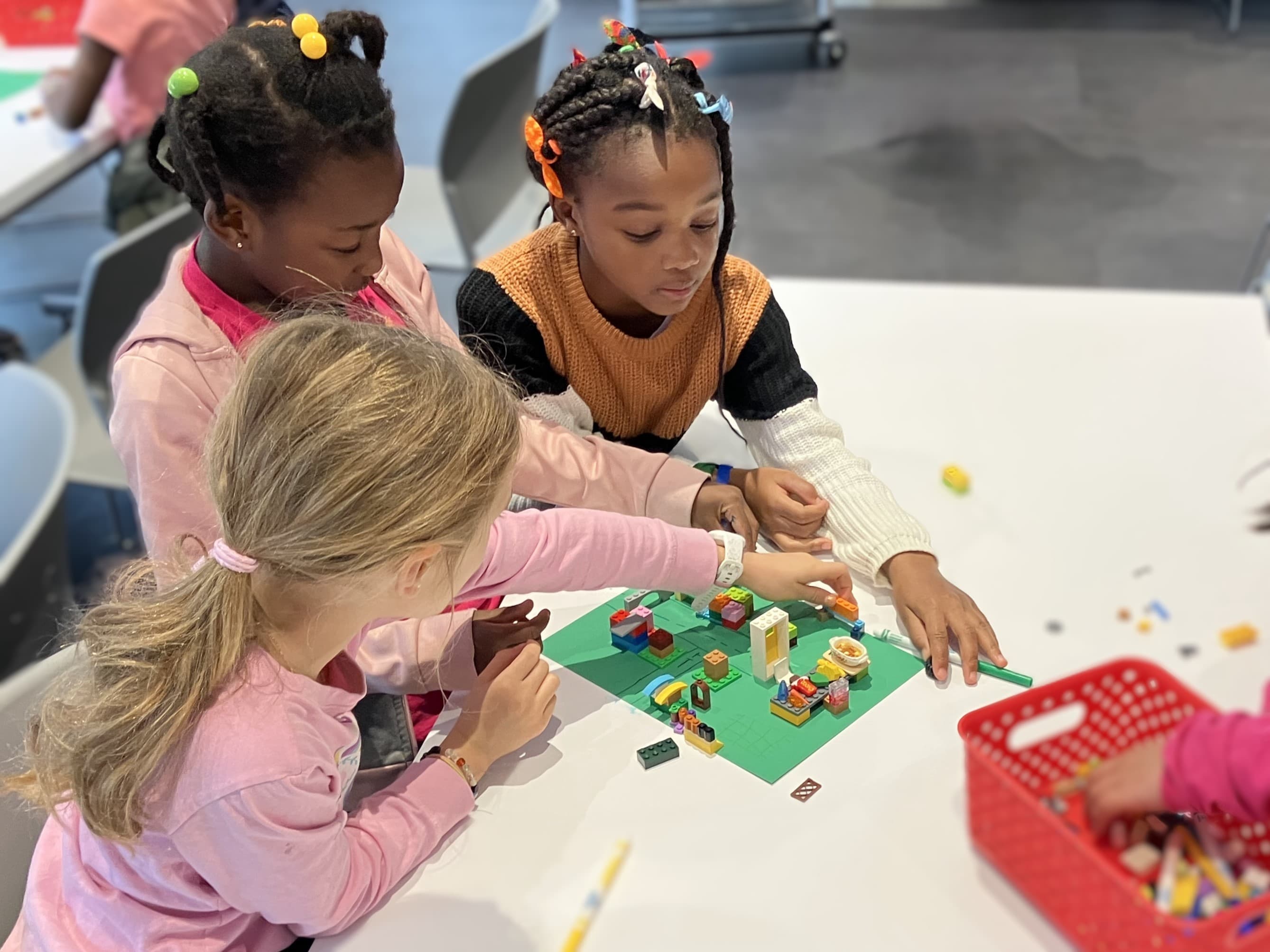 Three children play a construction activity