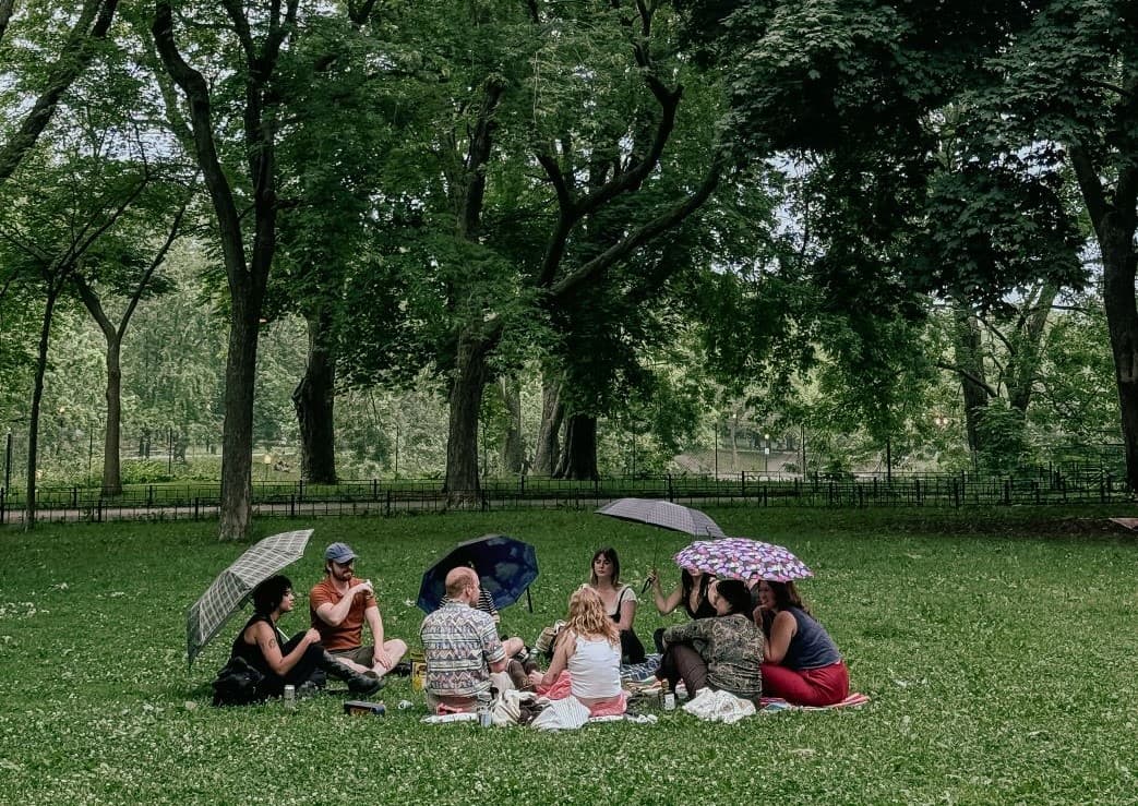 Photo of a group of people picnicking in a park