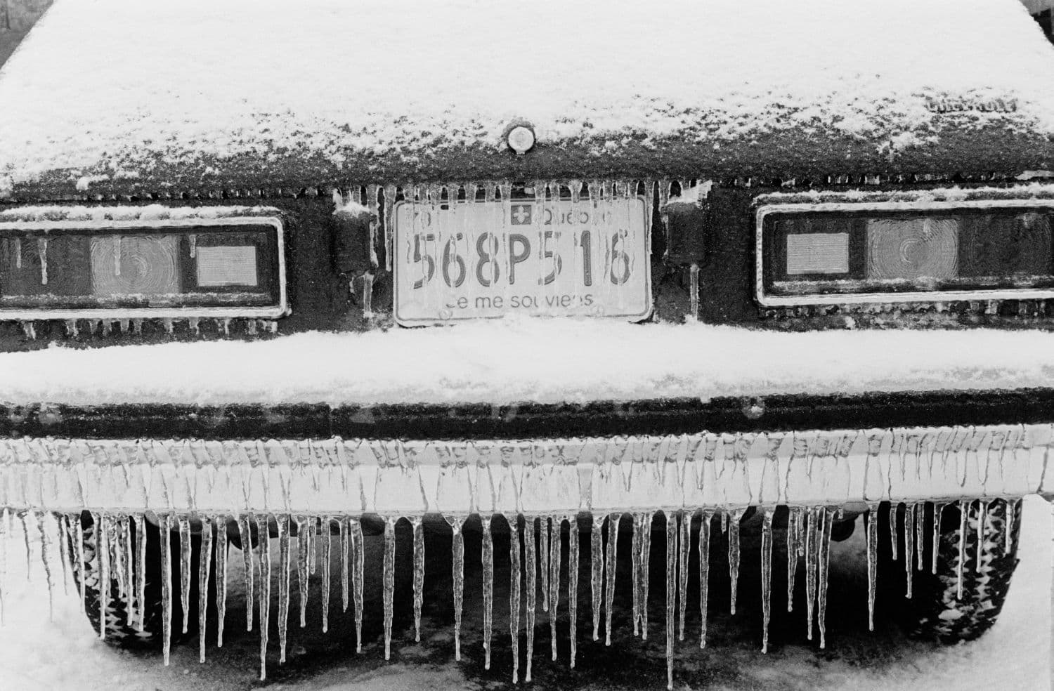 The front of a car coated in ice.
